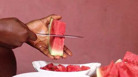Person picking water melon slice from a bowl. Hand holding water melon	 Stock Footage 205530808