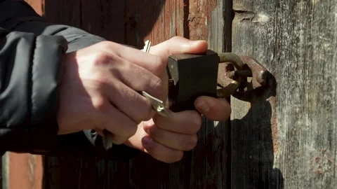 A person picks up keys in an old lock Stock Footage 185399899