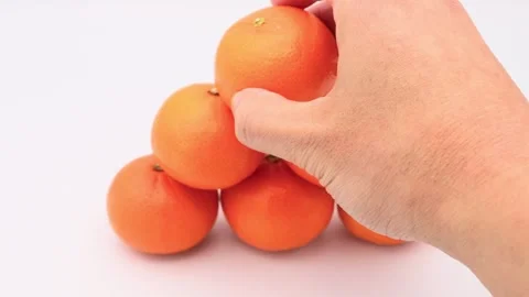 A person piling up oranges Video stock 336653779