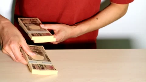 A person piling up stacks of cash Stock Footage 334743138