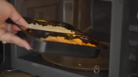 Person Placing Prepackaged Meal Into Microwave Stock Footage 339316012