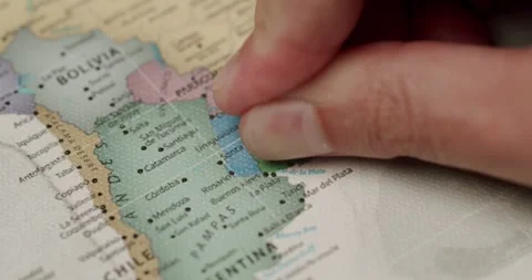 Person placing a red pin on a map of Uruguay Stock Footage 345587556