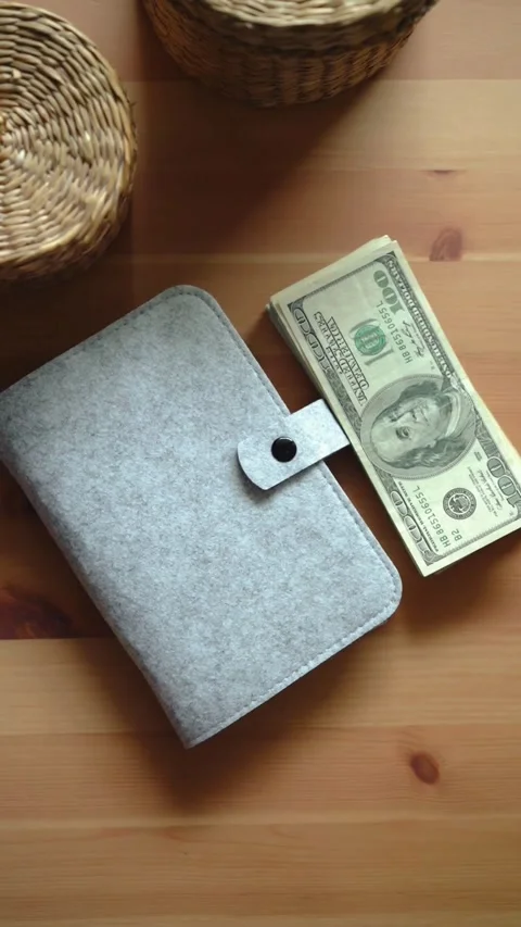 Person placing stack of hundred dollar bills on table Stock Footage 331772053