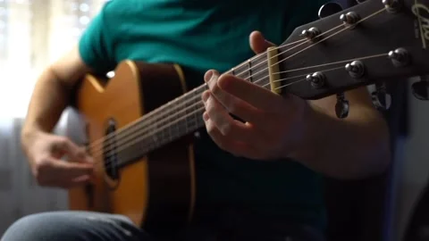 A person playing guitar. Video stock 217424780