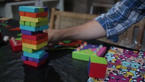  person playing jenga pulls the tower 스톡 동영상 123800001
