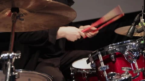 A person is playing red drum set, live on stage Stock Footage 319480074