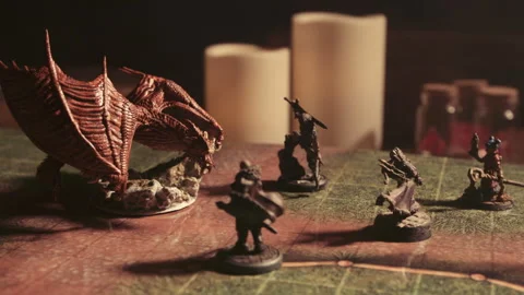 A person playing a tabletop roleplaying game with miniatures and dice Stock Footage 276479526