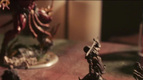 A person playing a tabletop roleplaying game with miniatures and dice Stock Footage 276479646