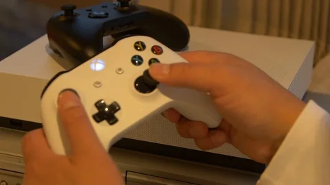 Person playing on xbox one s controller Stock Footage 120891400