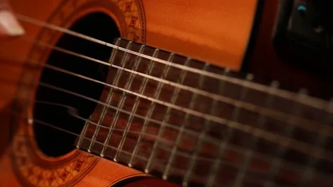 person plays the guitar and the strings vibrate and move 스톡 동영상 123799731