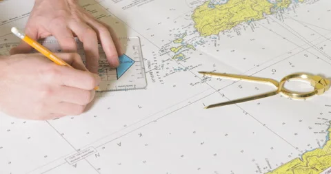 Person plots a course on the navy map Stock Footage 85517037
