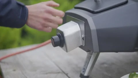 A person is plugging in a grill Stock Footage 297841980