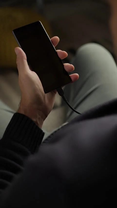 Person Plugging USB Cable into Phone Vertical Video stock 346810334
