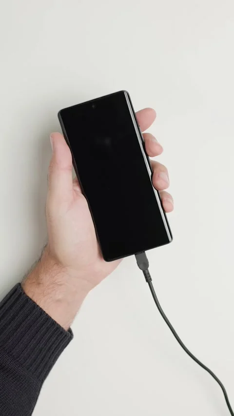 Person Plugging USB Cable into Phone Vertical Video stock 346810417