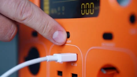 Person plugging USB cable into portable power station. Stock Footage 336198937