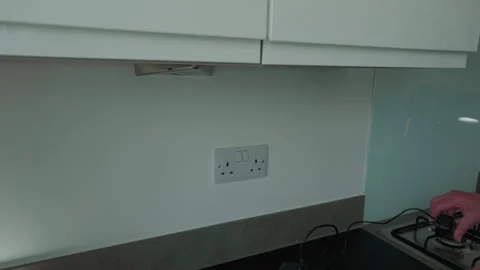 Person plugs device into wall socket Stock Footage 337317984