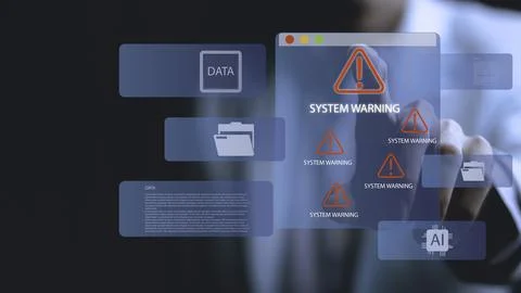 A person is pointing at a computer screen that has a warning sign on it Stock-Fotos