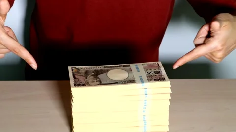 A person pointing to a pile of banknotes Stock Footage 334758798