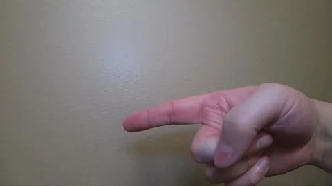 Person points finger in plain white light Video stock 141691378