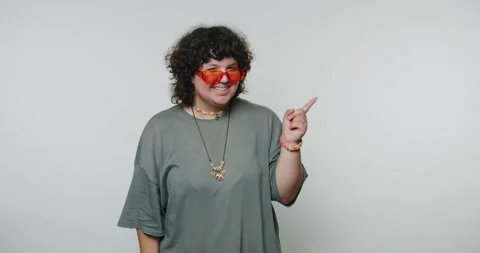 Person poses in fun red glasses and points at camera in indoor setting duri.. 動画素材 331990786