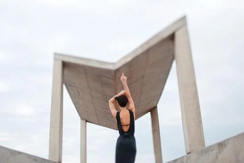 Person Posing in Front of Modern Architectural Structure Stock Photos
