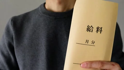 A person posing with a paycheck Stock Footage 324548542