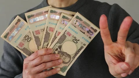 A person posing with a stack of bills Stock Footage 324545837