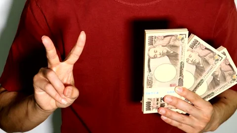 A person posing with a wad of cash. Video stock 334721848