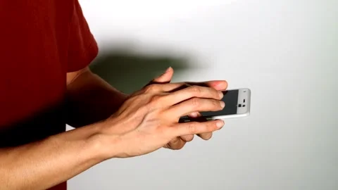 A person posing while operating a smartphone. Stock Footage 334696998