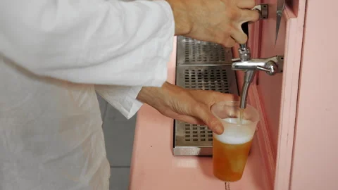Person Pouring Draft Beer From Tap Into Plastic Cup. Stock Footage 345781026