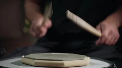 A person is practicing using drumsticks on a training pad. They are using a 스톡 동영상 280964615