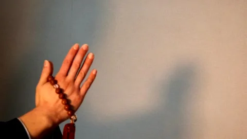 A person praying with prayer beads. Video stock 336038591