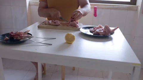 Person preparing and cutting raw chicken meat Stock Footage 322510955