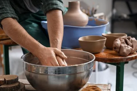 Person preparing clay for pottery in studio Stock Photos