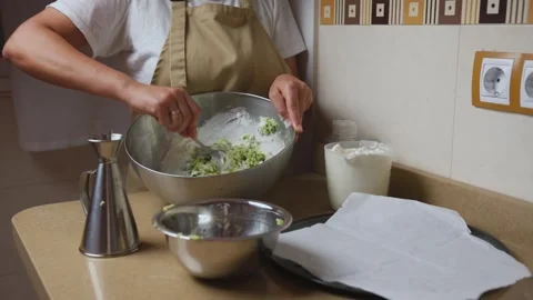Person Preparing Dough in Kitchen with Ingredients and Tools on Countertop Stock Footage 316859577