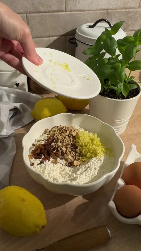 Person preparing lemon cake batter with raisins and nuts Stock Footage 337559768