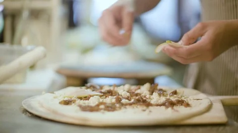 Person preparing pizza in kitchen Stock Footage 87806455