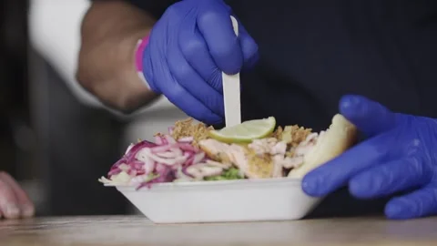A person is preparing a sandwich with a lime on it Stock Footage 301629607