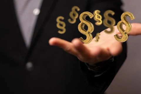 A person presenting the 3D render of paragraph section signs - law and justic Stock Photos