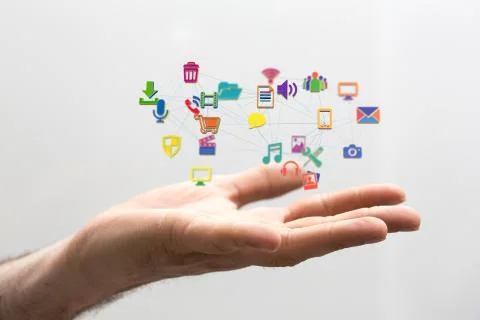 Person presenting a virtual projection of cloud computing icons Stock Photos