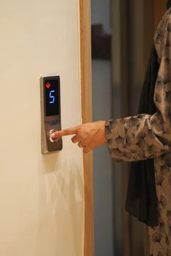 Person presses elevator button at a building Stock Photos