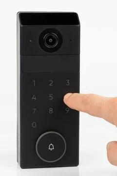 Person pressing button on black smart doorbell device Stock Photos
