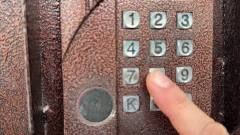 Person pressing button on door intercom keypad outdoors to open entrance door, Stock Footage 337104621