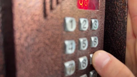 Person pressing button on door intercom keypad outdoors to open entrance door, Stock Footage 337104646