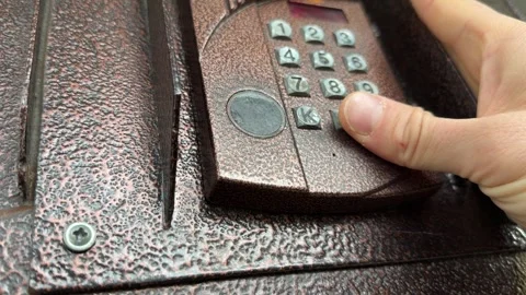 Person pressing button on door intercom keypad outdoors to open entrance door, Stock Footage 337104660