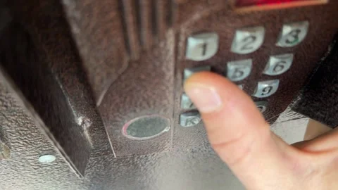 Person pressing button on door intercom keypad outdoors to open entrance door, Stock Footage 337104665
