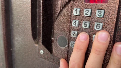 Person pressing button on door intercom keypad outdoors to open entrance door, Stock Footage 337104666