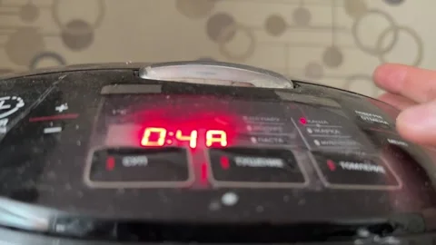 Person pressing button on multicooker control panel close up at home, starting Stock Footage 337104806