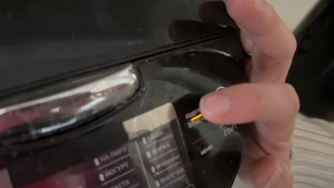 Person pressing button on multicooker control panel close up at home, starting Stock Footage 337104822