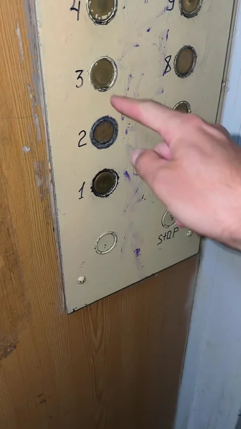 Person Pressing Button on an Old Vandalized Elevator Panel Stock Footage 314880215